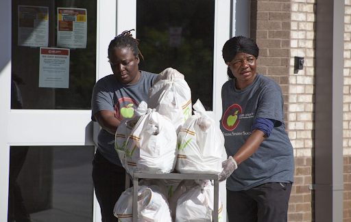 “Lunch ladies help by giving out free lunch kits for families during the pandemic.”