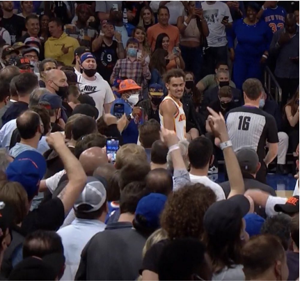 Trae Young smiling at an angry Knicks fans in the stadium during the playoffs last season.