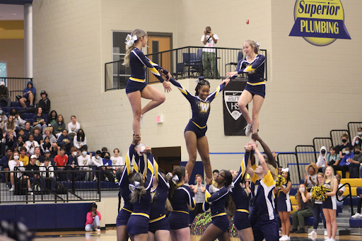 It takes a lot of strength and teamwork to be able to pull off a 3 person stunt like this. This is our competition team performing their routine during the pep rally. Aya Al-Qutub (11)
