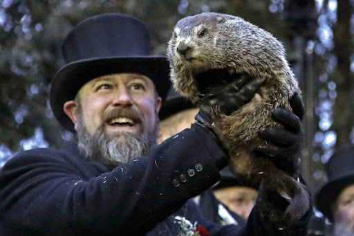 Groundhog Club co-handler John Griffiths co-handler Al Dereume holds Punxsutawney Phil, the weather prognosticating groundhog, during the 133rd celebration of Groundhog Day on Gobbler’s Knob in Punxsutawney, Pa. Saturday, Feb. 2, 2019. Phil’s handlers said that the groundhog has forecast an early spring. 
AP/Gene J. Puskar.
