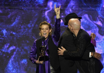Carlile (depicted on the left) on the stage at the Grammys Premiere Ceremony, accepting her newly won Grammy. 